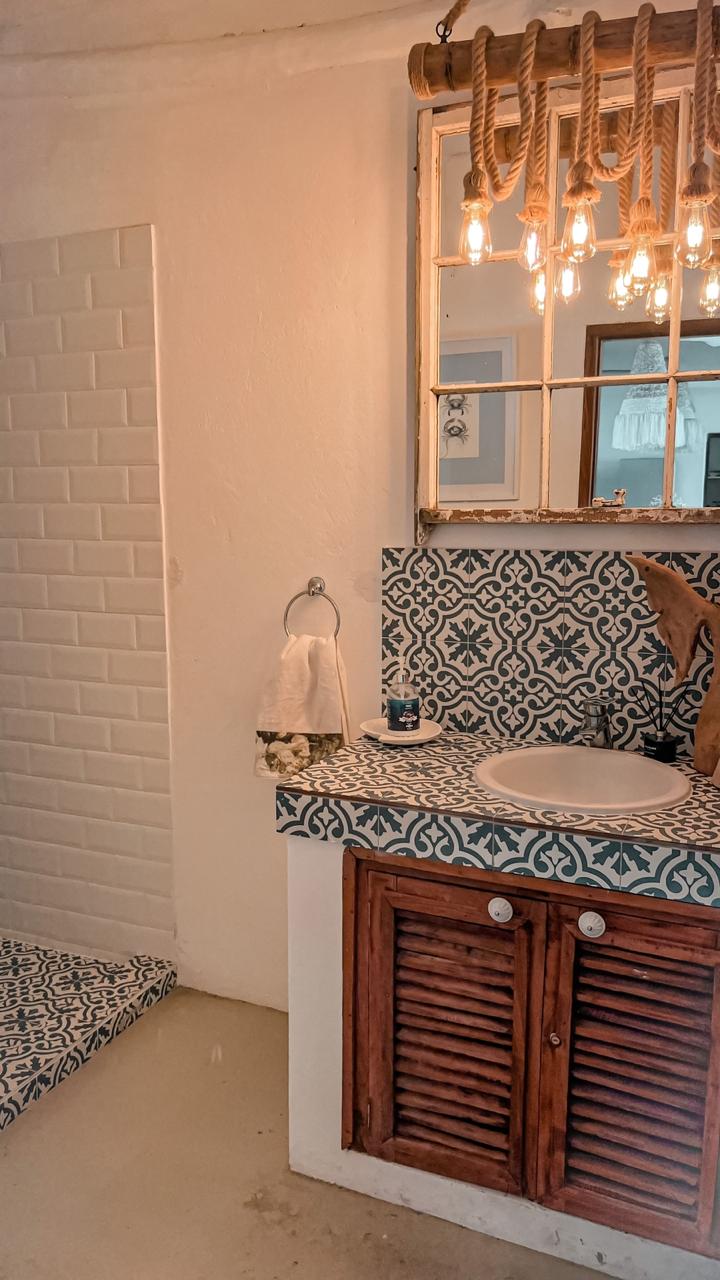 Moorish-tiled bathroom with rope chandelier