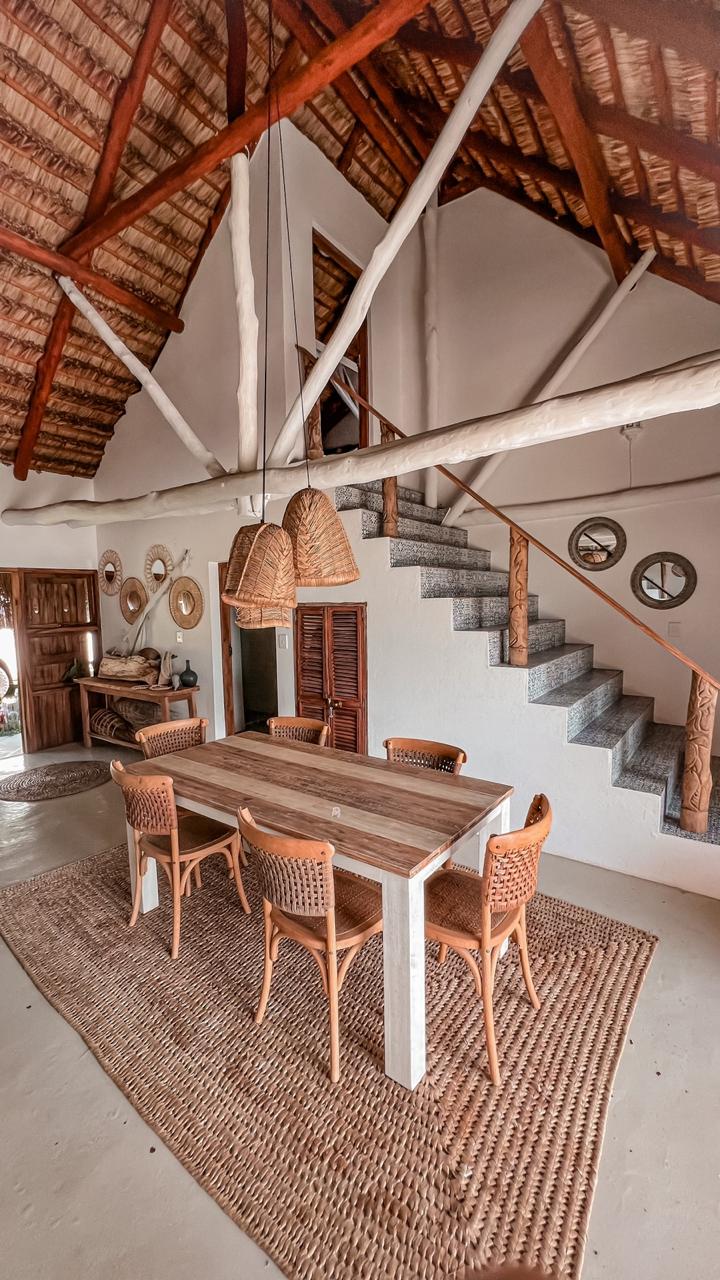 Indoor dining under a soaring thatched ceiling